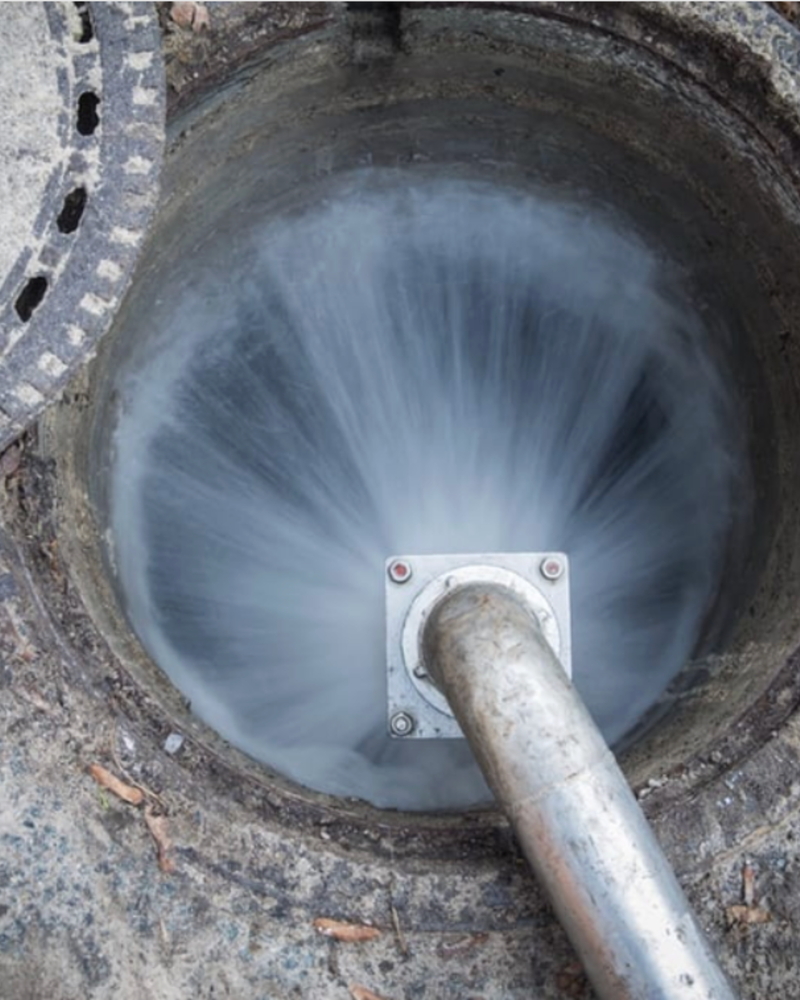High-Pressure Water Jet Cleaning Inside a Manhole