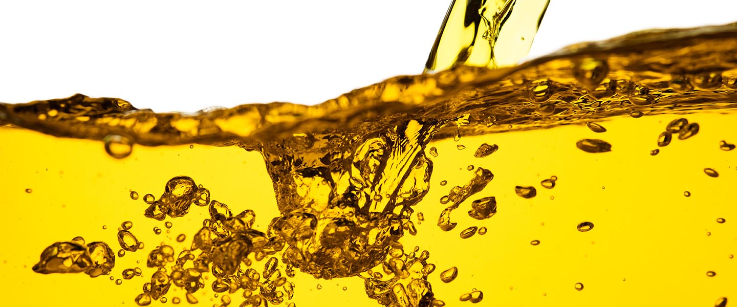 Golden liquid splashing and swirling with air bubbles